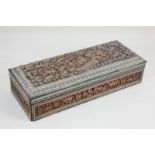 An Eastern ornately carved hardwood box, decorated with animals amongst foliage, with inlaid bone
