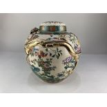 A Japanese pottery ginger jar and cover, baluster shaped, decorated in relief with a dragon and