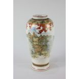 A Japanese Satsuma pottery vase, decorated with a scene of pagodas in a valley amongst trees,