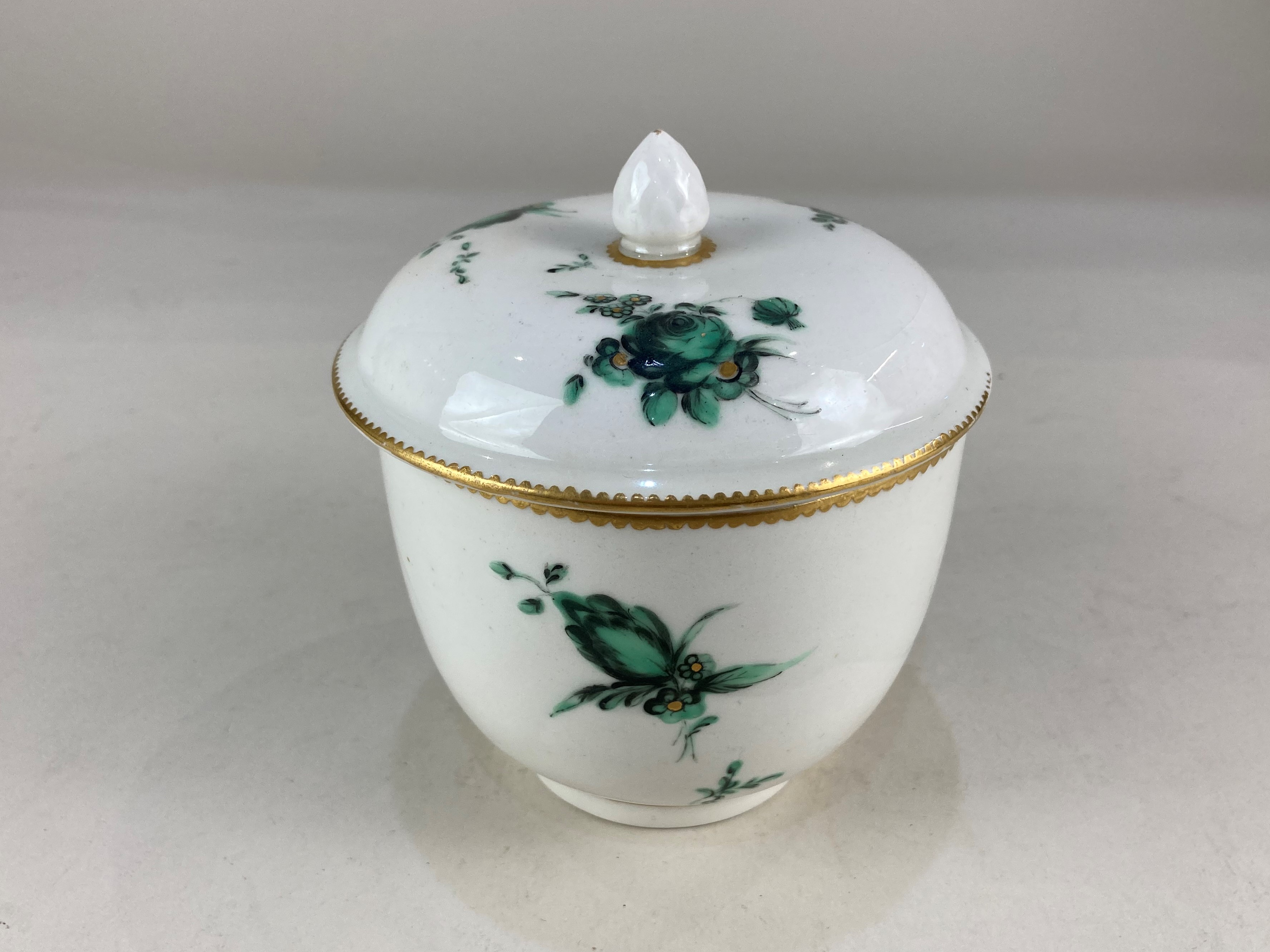 A Chelsea Derby porcelain sucrier and cover, painted with green flower sprays, with gilt