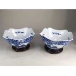 A pair of Chinese porcelain blue and white lobed bowls, decorated with panels of figures amongst