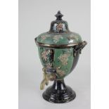 A Victorian pottery samovar, decorated with fruiting vines, on green and black banded ground, with
