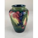 A Moorcroft pottery vase, of inverted baluster form, decorated with grapes and vine leaves on