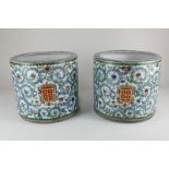 A pair of oriental porcelain cache pots, of cylindrical form, each decorated with an armorial