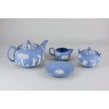 A Wedgwood blue jasper ware tea set, decorated in low relief with classical scenes, comprising tea