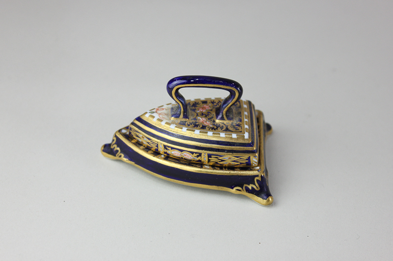 A Royal Crown Derby Imari miniature porcelain model of a flat iron on stand, 7cm