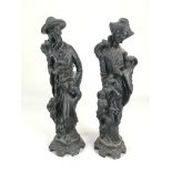 A pair of Oriental black painted carved wood figures of a gentleman and a lady, 37cm high