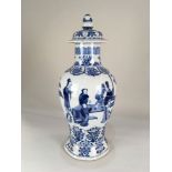 A Chinese blue and white porcelain vase and cover, decorated with a continuous scene of figures in a