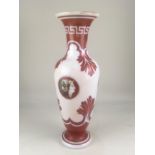 A 19th century opaque white glass vase, with rust coloured classical decoration, 35cm high