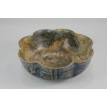 A Persian pottery bowl, of lobed circular form, decorated with figures, birds and other animals,