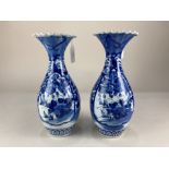 A pair of Chinese blue and white porcelain vases, with everted wavy rims, decorated with flowers and