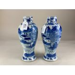 A pair of Chinese blue and white porcelain baluster vases, depicting fishermen amongst a