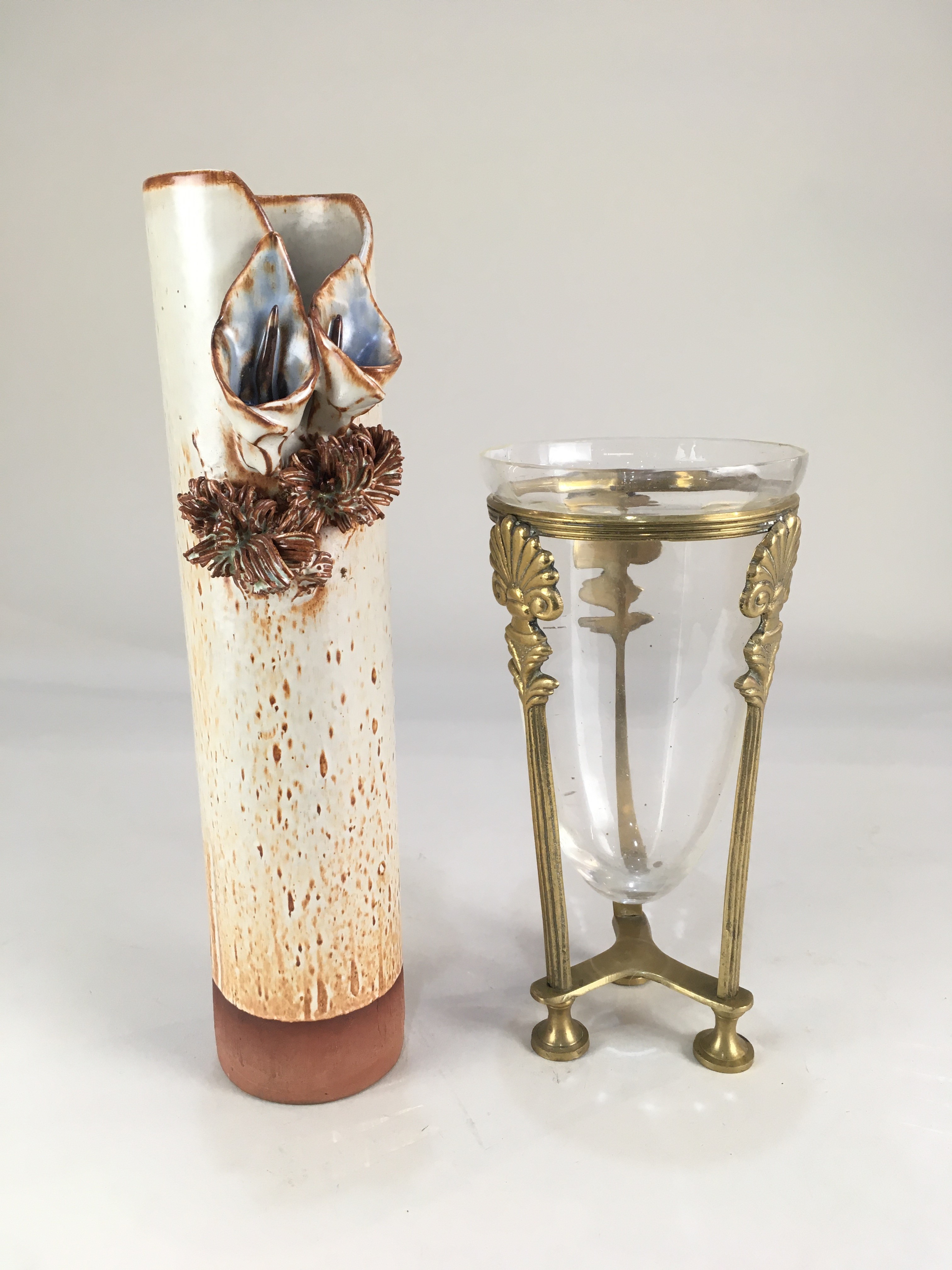 A 20th century glazed pottery vase, of cylindrical form, decorated with two applied calla lilies,