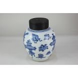 A Chinese blue and white ginger jar and wooden cover, depicting urns and vases, 17cm high
