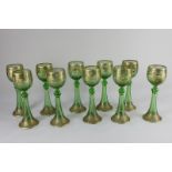 A set of ten Moser style Bohemian wine glasses, in green, each with trumpet shaped stem, decorated