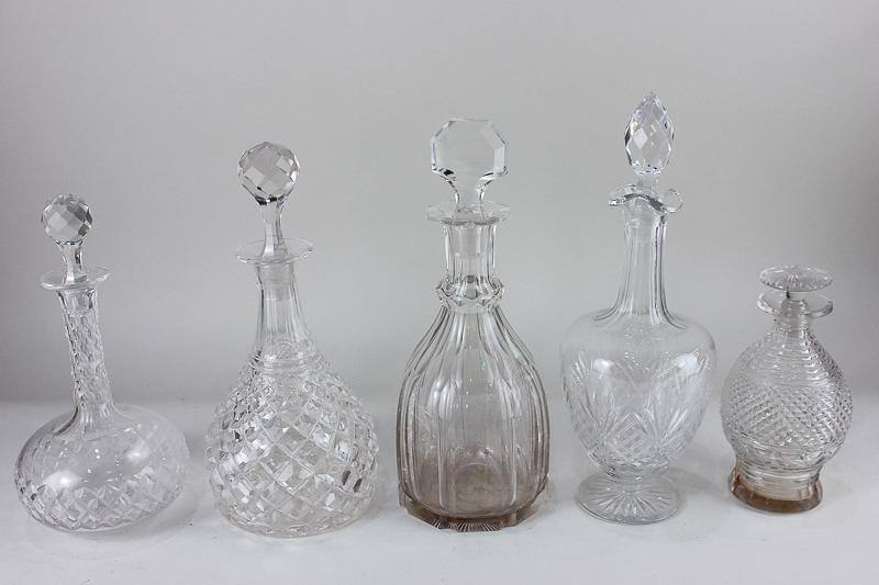 A collection of five various cut glass wine and spirit decanters, tallest 32.5cm high