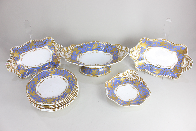 A Spode Felspar porcelain part dessert service, decorated in gilt on a band of blue ground with
