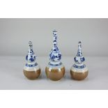 A set of three Chinese porcelain blue and white bottle vases, depicting flowers, vases and other