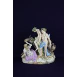 A Meissen porcelain figure group of the drunken Silenus, depicting Silenus supported by Bacchus