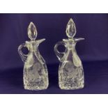 A pair of cut glass oil and vinegar bottles and stoppers, with floral design, 17cm high