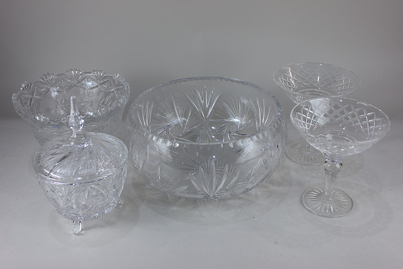 A large cut glass fruit bowl decorated with pinwheel star design, a similar jar and cover, a pair of
