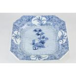 A Chinese porcelain blue and white dish, of canted square form, decorated with a flowering branch