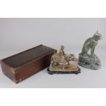 A Chinese carved hardstone model of a child seated on a buffalo, beside a calf, on wooden stand,