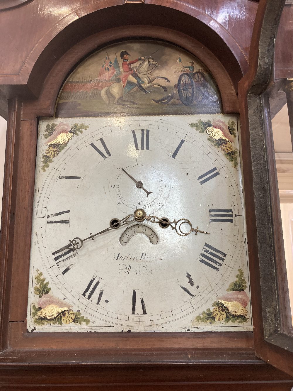 A 19th century inlaid flame mahogany longcase clock, the 14inch domed dial with painted face,