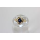 A sapphire and diamond cluster ring in 18ct gold