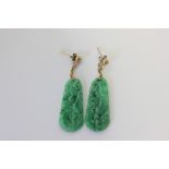 A pair of carved and pierced jade drop earrings
