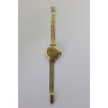 A lady's 18ct wristwatch by J. W. Benson on a 9ct gold bracelet