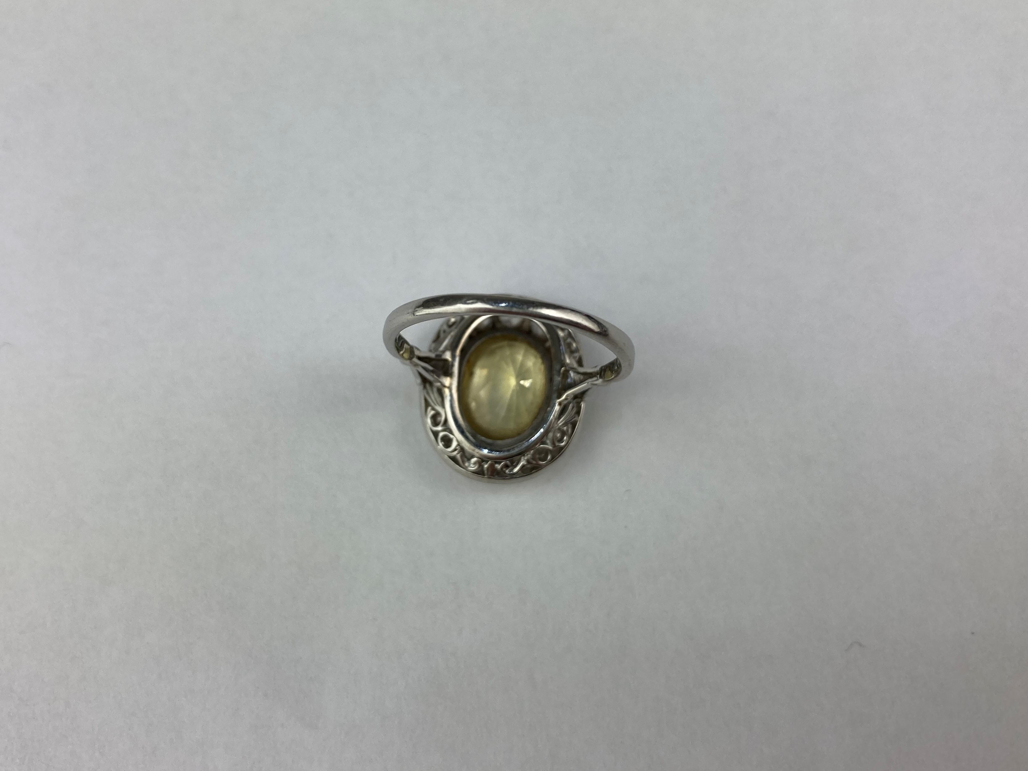 A yellow sapphire and diamond cluster ring, the oval cut stone within a border of old cut diamonds - Image 3 of 3