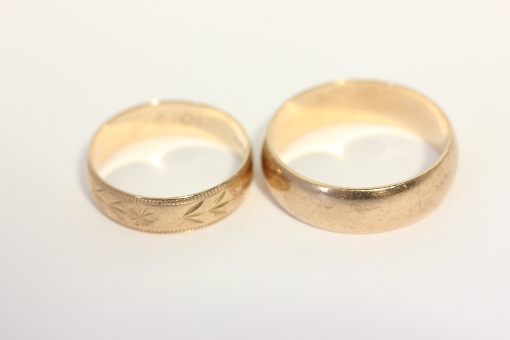 A 9ct gold wedding band, and another with leaf engraving 6.4g