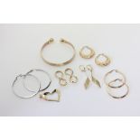 A 9ct three colour gold open end bangle, a pair of 9ct white gold hoop earrings, four pairs of 9ct