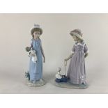 Two Lladro porcelain figures of girls, one playing with a doll, the other pulling a truck containing