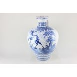 A Continental glazed pottery flagon, decorated in blue with a deer in a landscape, on white