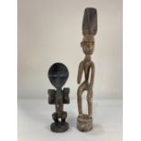 Two African carved hardwood figures, one wearing a hat, 57cm, the other with raised hands, 34cm