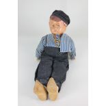 A 20th century Dutch boy doll, with composition head and cloth body, dressed in blue cap,