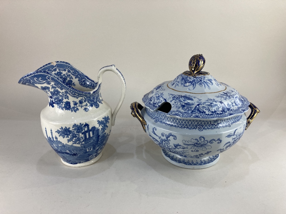 A blue and white ceramic two-handled soup tureen and cover with floral decoration, gilt and navy bud