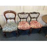 A pair of Victorian carved mahogany balloon back dining chairs, with cream and pink floral