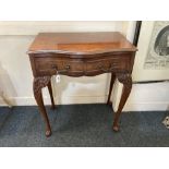 A reproduction walnut serpentine fronted side table, with two drawers, on slender carved cabriole