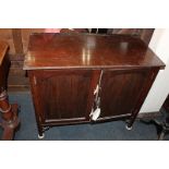 An early 20th century mahogany cabinet, rectangular top above two moulded panel doors, on square