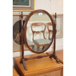 A Victorian mahogany oval toilet mirror on turned stand