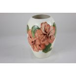 A Moorcroft 'Hibiscus' pottery vase, of tapered form, decorated with pink flowers on cream ground,
