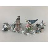 Two Lladro porcelain models of birds on flowering branches, a model of a cat with a mouse and a
