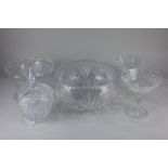 A large cut glass fruit bowl decorated with pinwheel star design, a similar jar and cover, a pair of