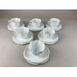 A Shelley porcelain tea set for six, of scalloped floral form in white glaze, comprising six