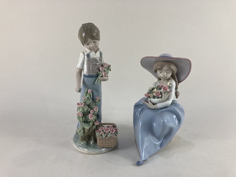 Two Lladro porcelain figures of a boy cutting roses and a girl holding a bouquet of flowers, tallest