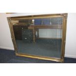 A large gilt framed rectangular wall mirror, with bevelled mirror plate, 107cm by 129cm