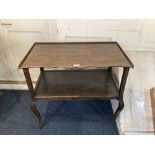 An oak two tier side table, with rectangular wavy fronted top, on slender cabriole legs, 73cm (a/f)